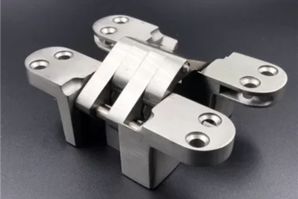 Stainless steel hidden cabinet hinges with a sleek, modern design for door mounting.