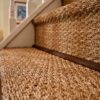 Stylish jute stair runner on a curved staircase with modern design and elegant neutral tones.