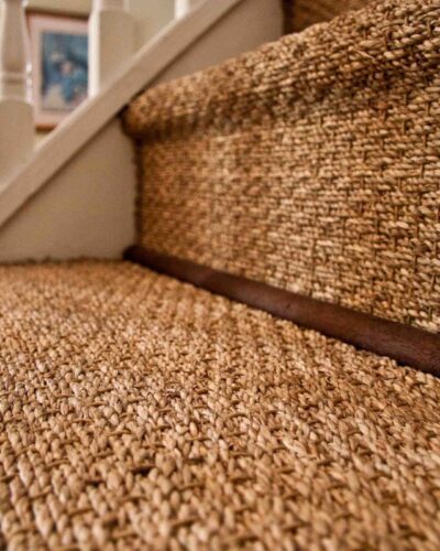 Stylish jute stair runner on a curved staircase with modern design and elegant neutral tones.