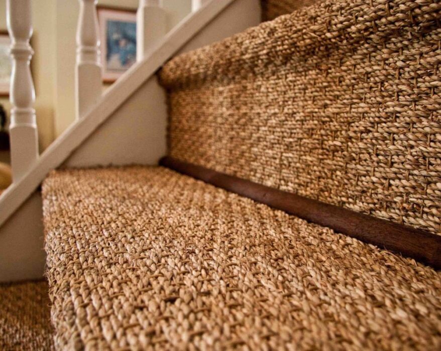 Stylish jute stair runner on a curved staircase with modern design and elegant neutral tones.