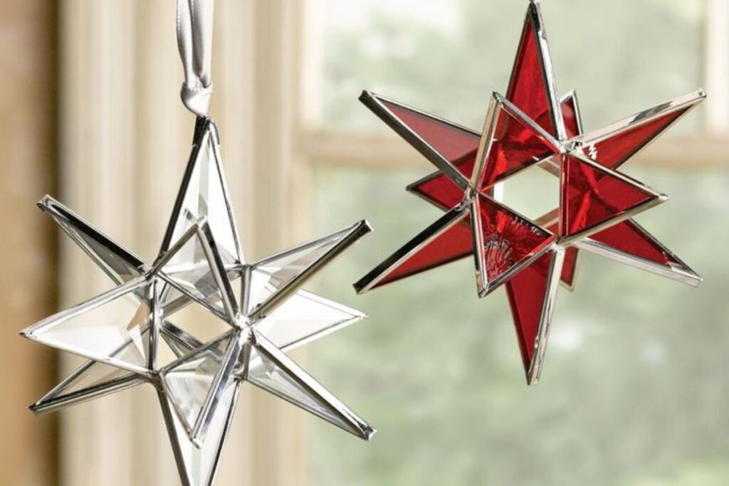 A set of small, decorative Moravian Stars made of geometric cutouts, showcasing their detailed structure in a delicate, compact design.
