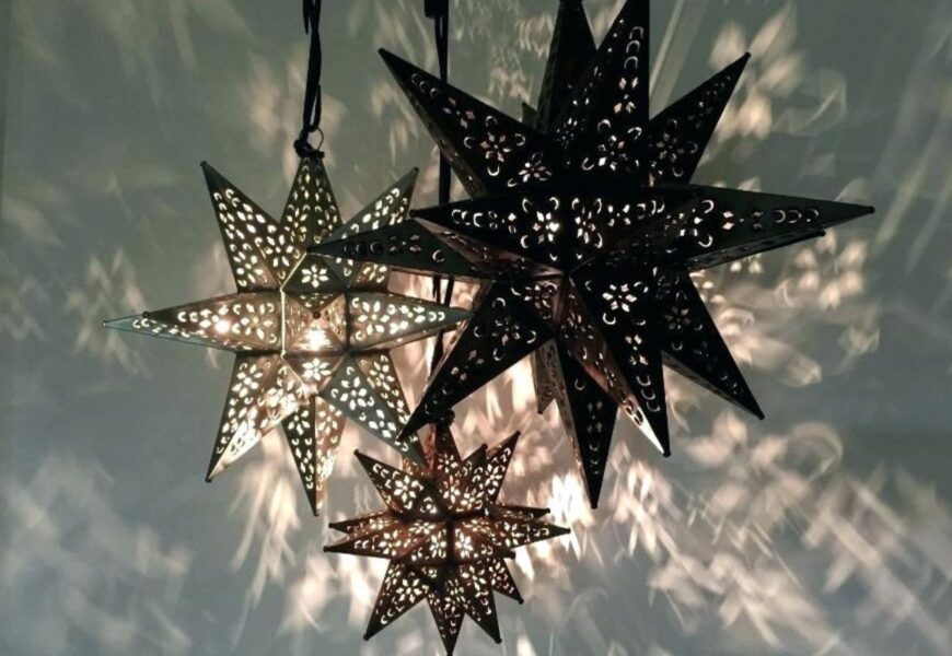 Moravian Star Lights with intricate cut-out designs, casting beautiful patterns on the wall, adding unique lighting to home decor.