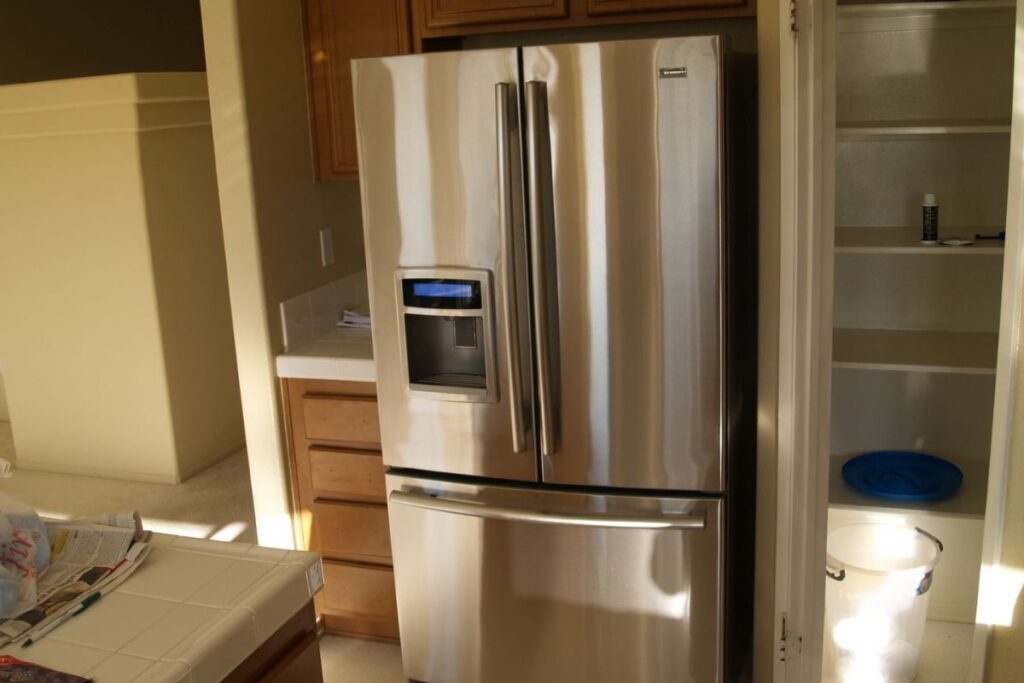 Various refrigerator cabinet surrounds showcasing different styles, including freestanding, full, and partial surrounds. These designs blend seamlessly with home décor, providing a clean and stylish finish to refrigerators. The images highlight how the surrounds complement modern kitchen aesthetics and help integrate appliances into the overall design.