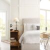 A modern home interior featuring Sherwin Williams Toque White walls, including a bright kitchen with white cabinetry, a cozy bedroom with soft neutral decor, and an elegant dining area with large windows, all creating a clean, airy, and inviting atmosphere.